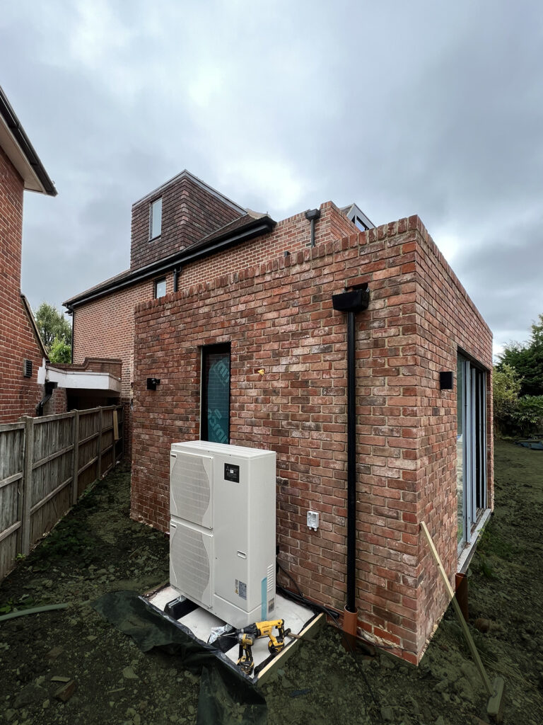 Red Brick House, Willesden, NW London. An extensive renovation and extension to a detached house following Passivhaus standards. The above image shows the heat pump installed at the back of the kitchen extension.