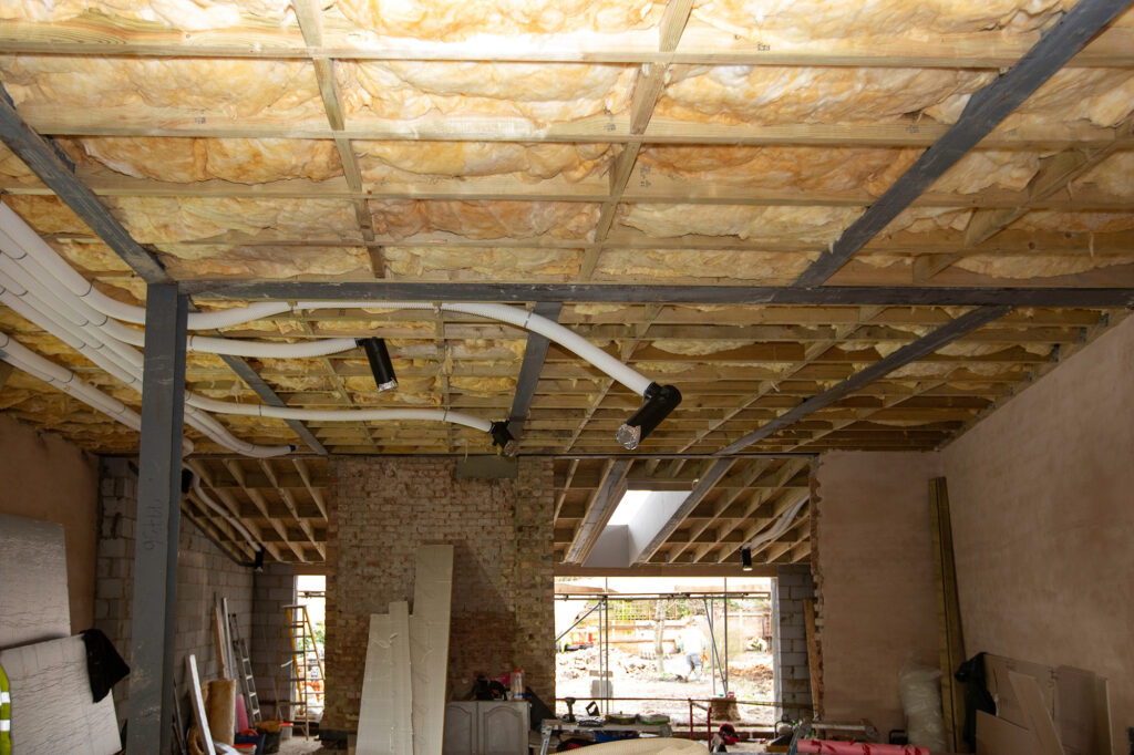 Insulation between floor joists at Herbert Paradise - a low energy home in Kensal Rise, North West London