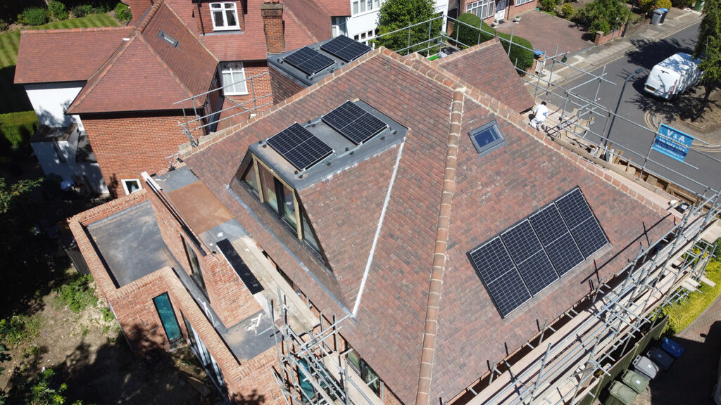 Image showing Integrated Solar Panels (In-roof Solar Panels) as well as on-roof Panels at our Red Brick House in Willesden, North West London. 