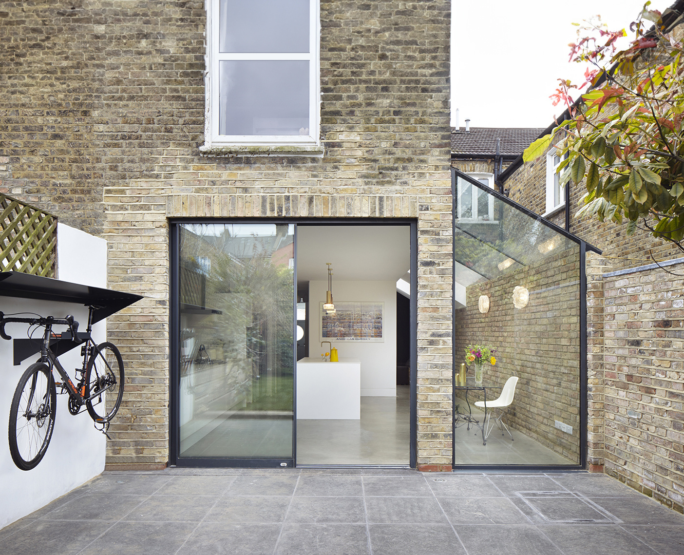 Modern brick house extension with glass doors and a sleek interior, illustrating design considerations for 'how much does a house extension cost' in London.