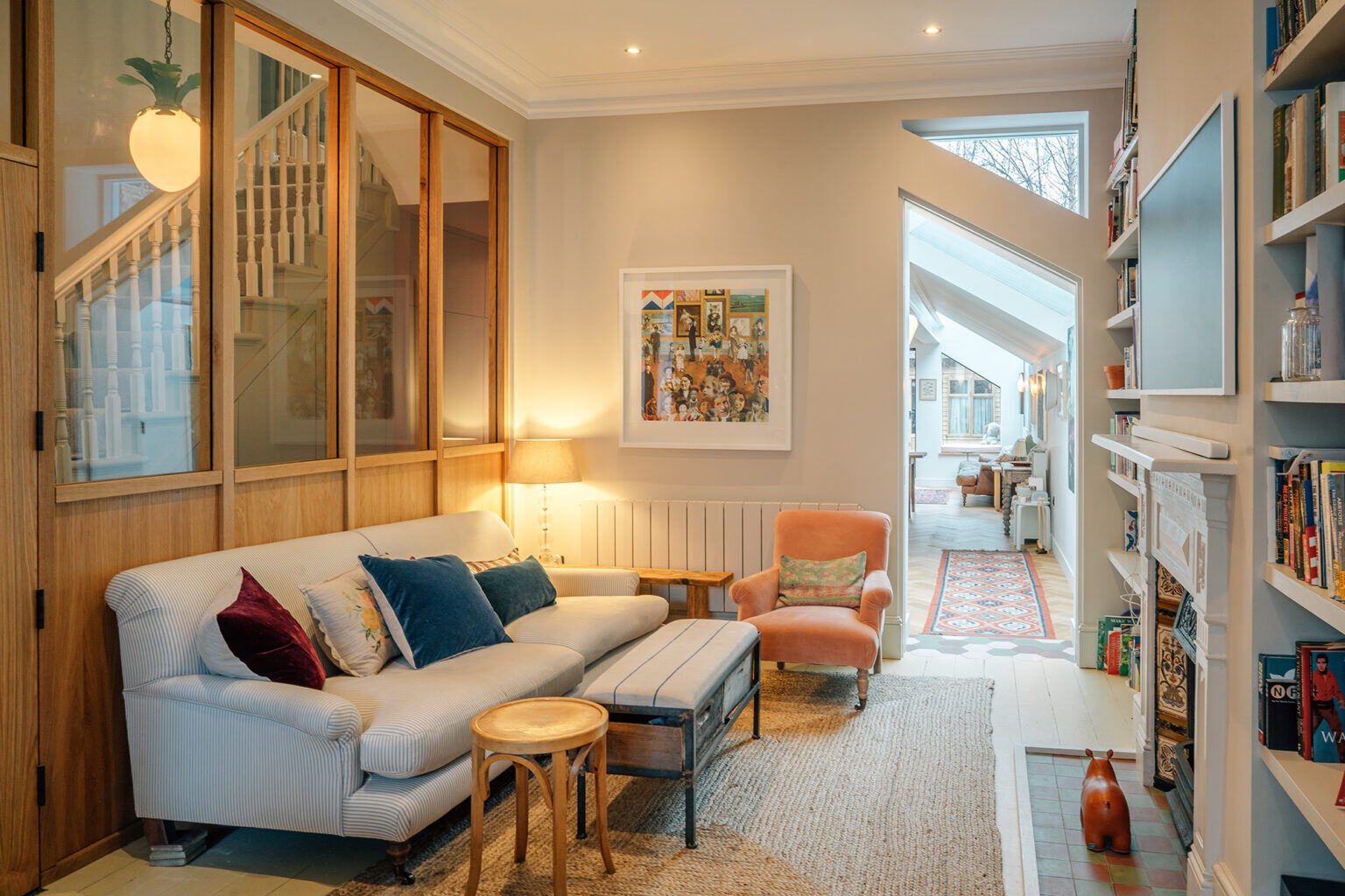 View of Living of Kempe Road in NW London converting two flats to one house by RISE Design Studio