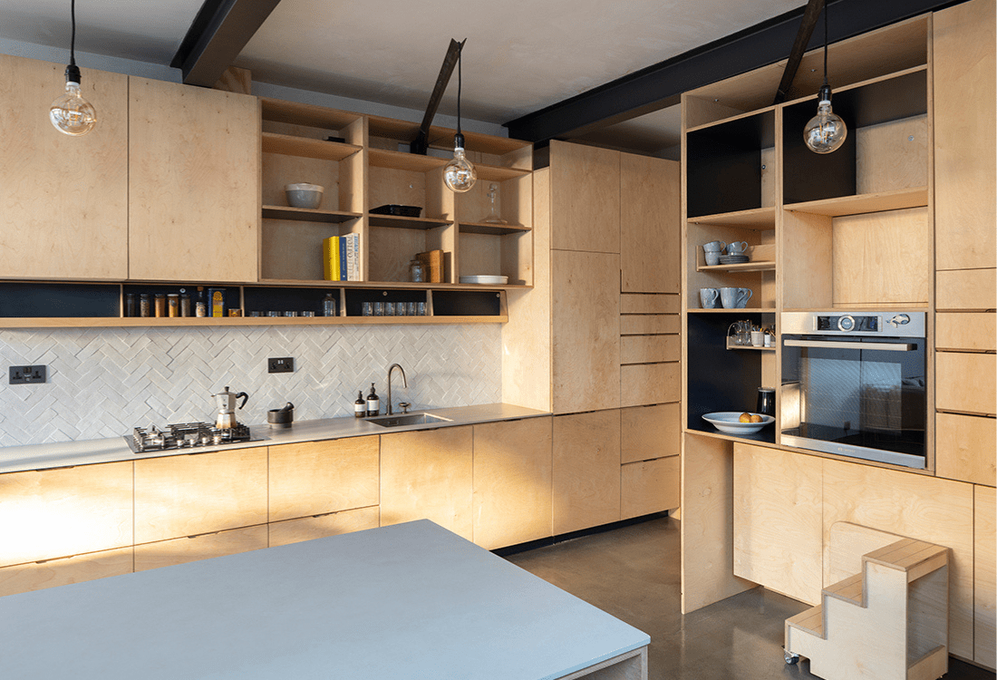 A modern kitchen featuring minimalist cabinetry, light wood finishes, and open shelving, illustrating how a space can redefine an interiors layout by merging functionality, aesthetics, and technology in line with the concepts of architectural innovation.