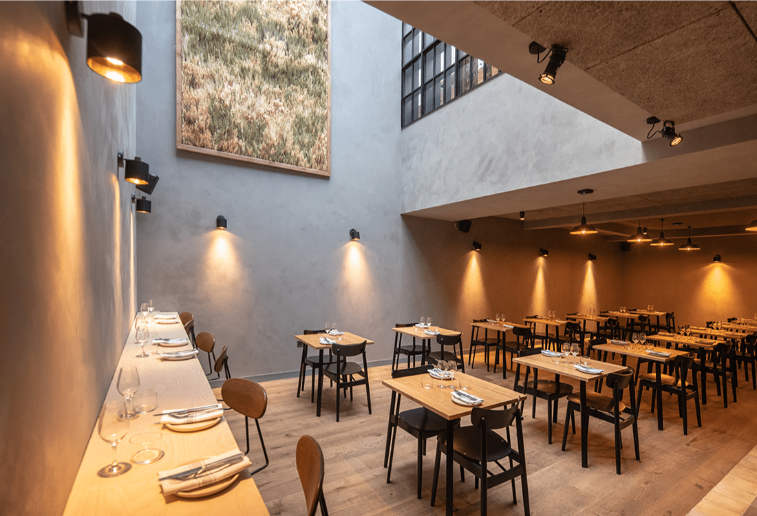 Modern dining space with minimalist design, natural lighting, and thoughtfully spaced tables, showcasing how cultural venues have adapted to post-pandemic priorities of comfort, safety, and aesthetic innovation.